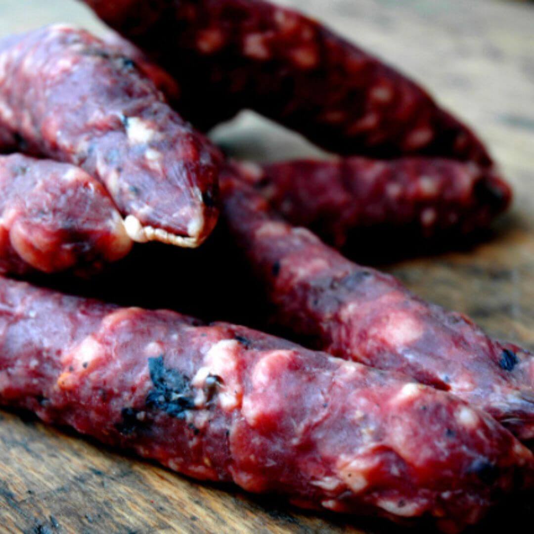 6 bosquito salami placed on a wooden board